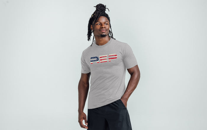 The REP Fitness Men's Daily Driver 2.0 USA Tri-Blend Crew T-Shirt in Heather Gray/White front, on model