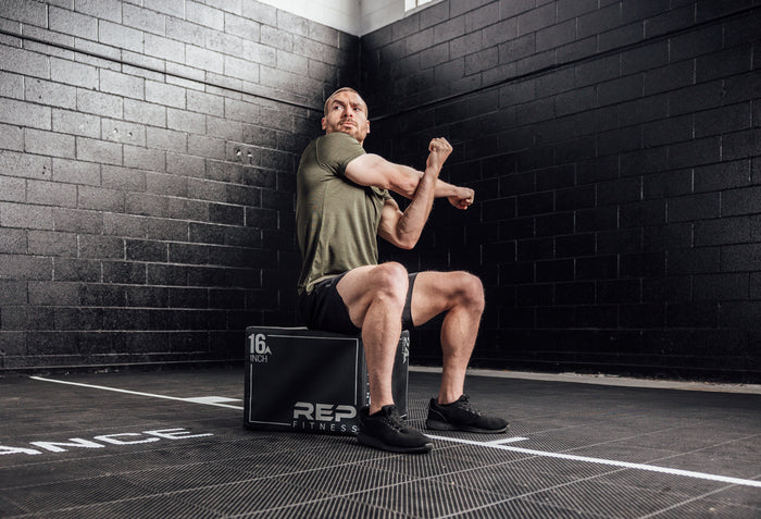 The REP Fitness Men's Sigmatech Shirt in Heather Olive front, stretching