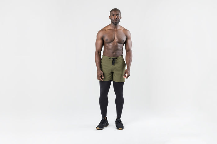 The REP Fitness Men's Virtus Light Compression Tights in Black front, worn under shorts