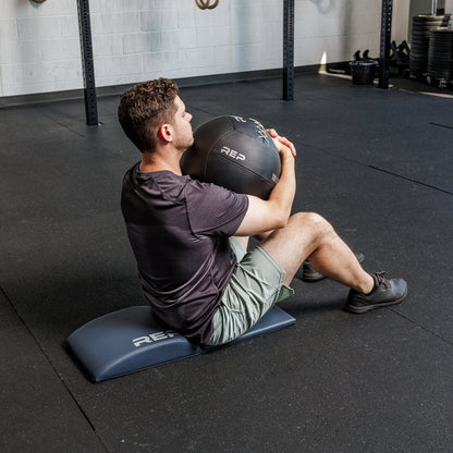 Athlete doing a sit up using the REP Fitness Ab Support Mat 2.0
