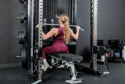 Athlete using the REP Fitness Altitude™ Leg Roller as a leg restraint while doing lat pulldowns