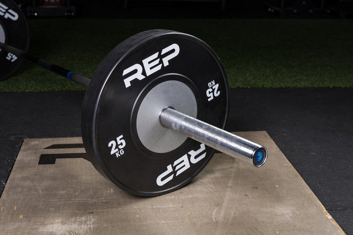Black Competition Bumper Plates (KG) loaded onto a barbell