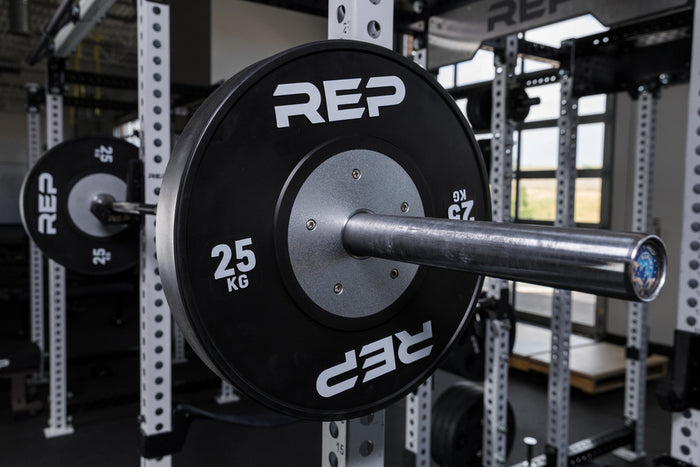 Black Competition Bumper Plates (KG) loaded onto a barbell racked on a PR-5000 rack