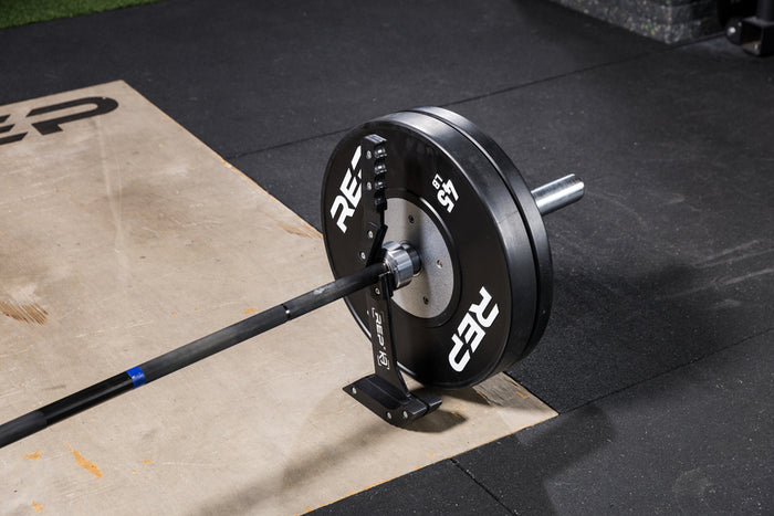 Black Competition Bumper Plates (LB) loaded onto a barbell with the Kleva Deadlift Jack