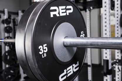 Black Competition Bumper Plates (LB) loaded onto a barbell