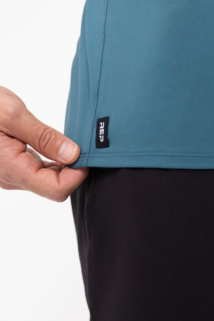 The REP Fitness Men's Delta Shirt in Slate front, hem detail