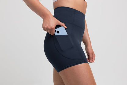 The REP Fitness Women's Forma Shorts in Navy on body, pocket detail