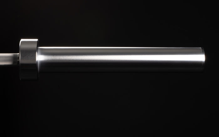 Close-up view of the smooth sleeve of a racked REP 15kg Colorado Bar.