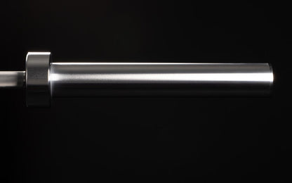 Close-up view of the smooth sleeve of a racked REP 15kg Colorado Bar.