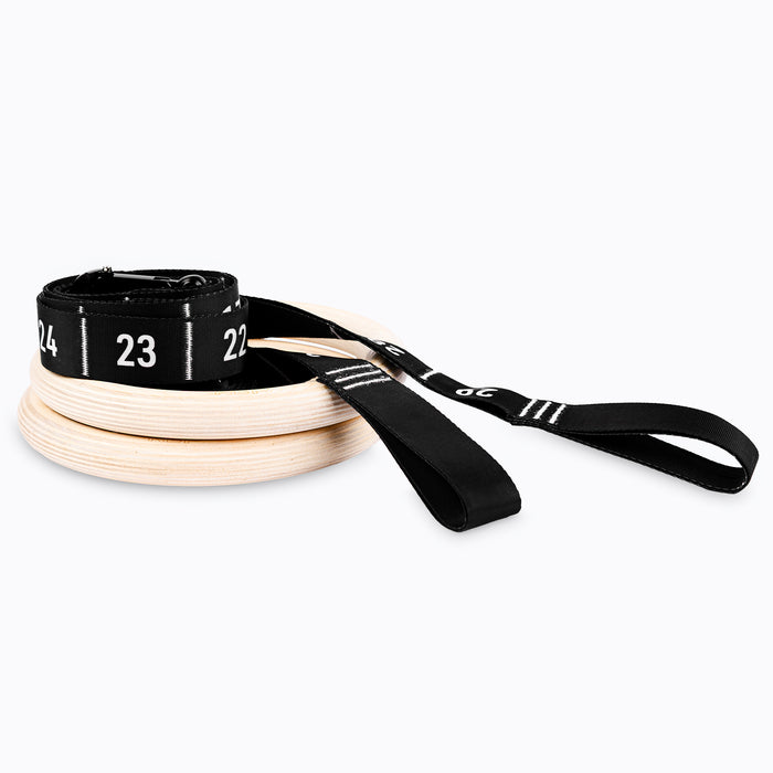 Studio-shot of the REP Competition Gymnastic Straps and Wood Rings rolled up