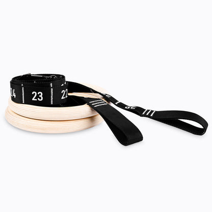 Studio-shot of the REP Competition Gymnastic Straps and Wood Rings rolled up