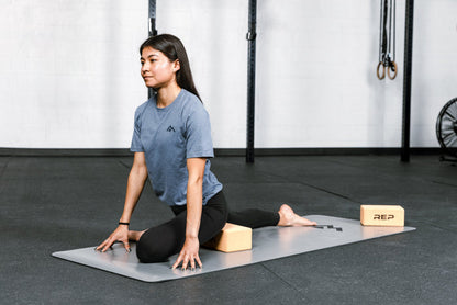 Athlete performing a stretch with REP's cork yoga blocks.