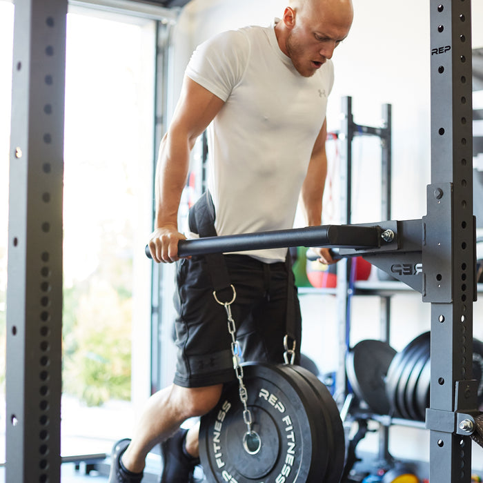 Athlete doing weighted dips on the REP Fitness Dip Station for the 4000 series