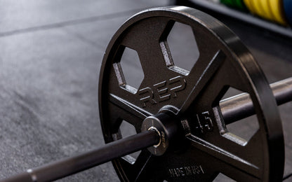 Close-up view of a 45lb USA-Made Equalizer Iron Plate loaded on a barbell.