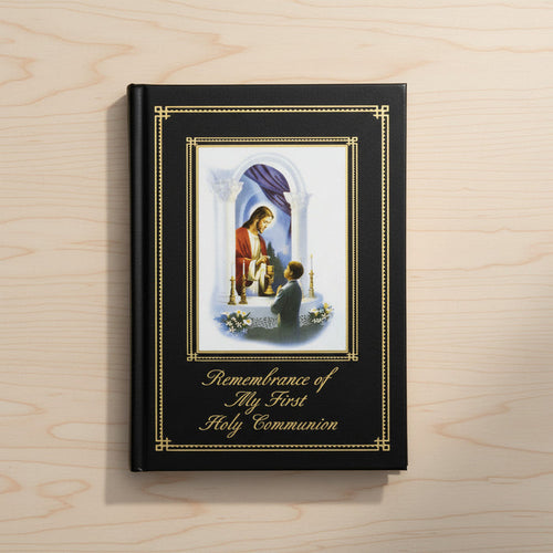 Book titled 'Remembrance of My First Holy Communion' with a religious illustration on a wooden surface