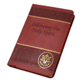 Red and gold foil prayer book on a white background.