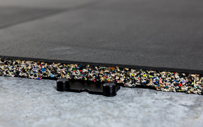 Close-up of one Interlocking Floor Tile connected to one side of one four-way dowel connecting piece