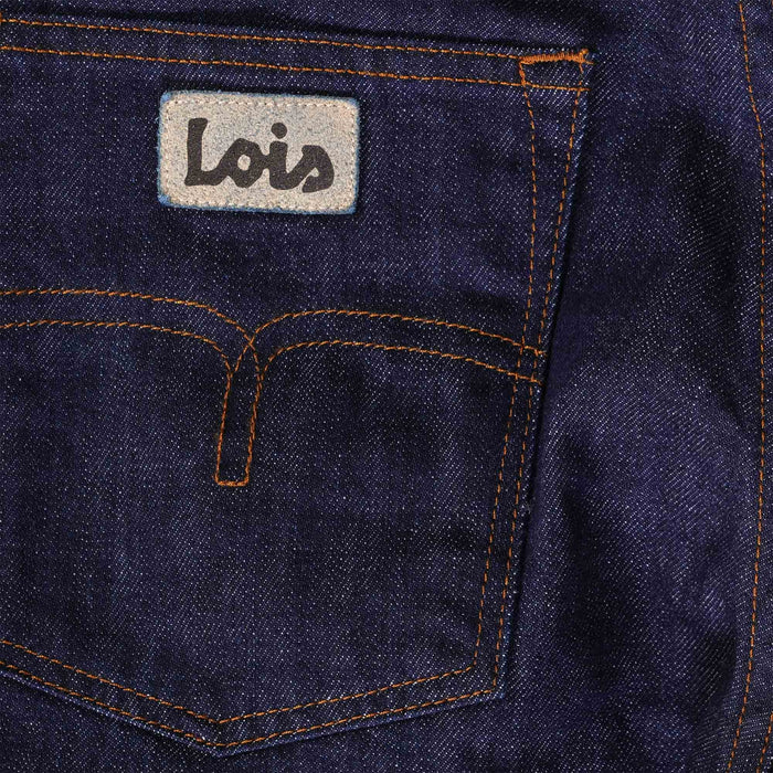 Close-up of the back pocket of men's dark blue jeans with the brand logo and stitching.