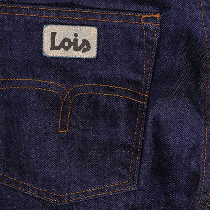 Close-up of the back pocket of men's dark blue jeans with the brand logo and stitching.