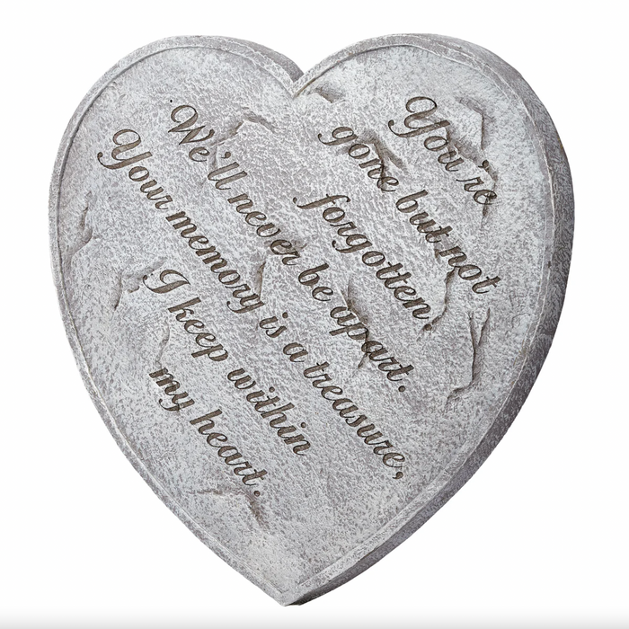 Heart-shaped stone with engraved text on a white background