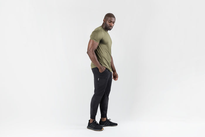 The REP Fitness Men's Apollo Joggers in Heather Black front, lifestyle 3/4 angle