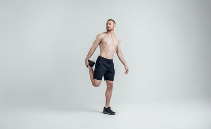 The REP Fitness Men's Apollo Shorts in Heather Navy/Cool Gray front, stretching