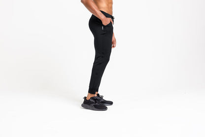 The REP Fitness Men's Attis Joggers in Heather Black front, side profile, hand in pocket
