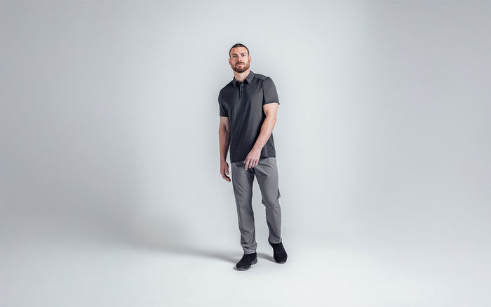 The REP Fitness Men's Audax Performance Polo in Heather Black/Cool Gray front, head turned