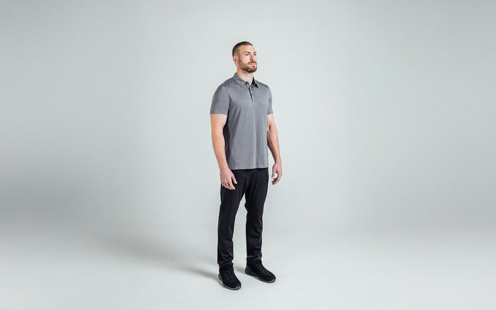 The REP Fitness Men's Audax Performance Polo in Heather Cool Gray/Black front, 3/4 angle