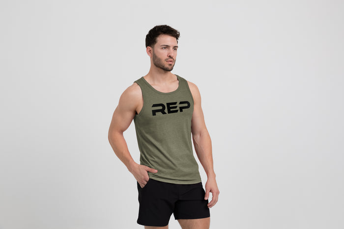 The REP Fitness Men's Daily Driver Tri-Blend Tank in Heather Olive/Black on model