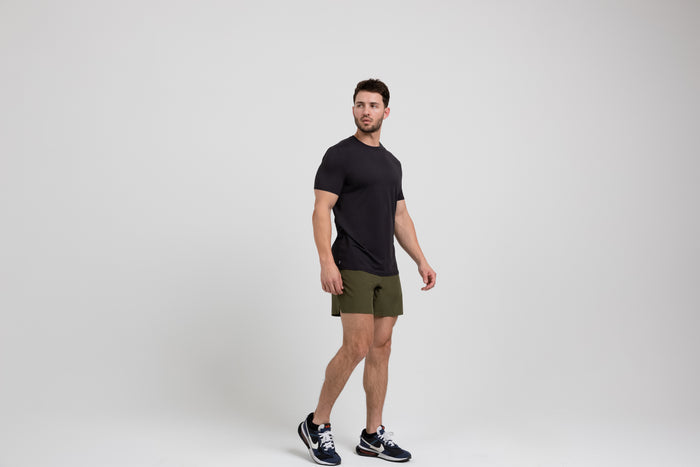 The REP Fitness Men's Delta Shirt in Black front, side-profile walking