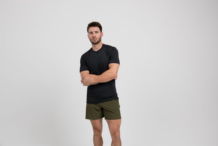 The REP Fitness Men's Delta Shirt in Black front, arms crossed