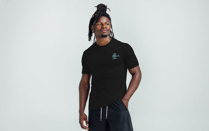 The REP Fitness Men's Feeling Swell Tri-Blend Crew T-Shirt in Heather Black/Blue front, hand in pocket