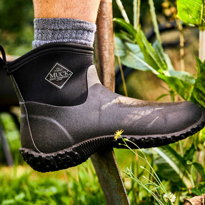 M2A000 Muckster II Men's Ankle  Muck boot worn by a person in a garden setting