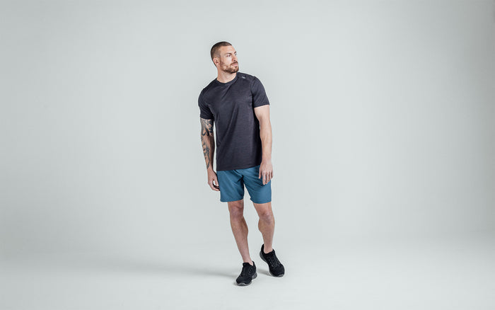 The REP Fitness Men's Sigmatech Shirt in Heather Black front, head turned to the side
