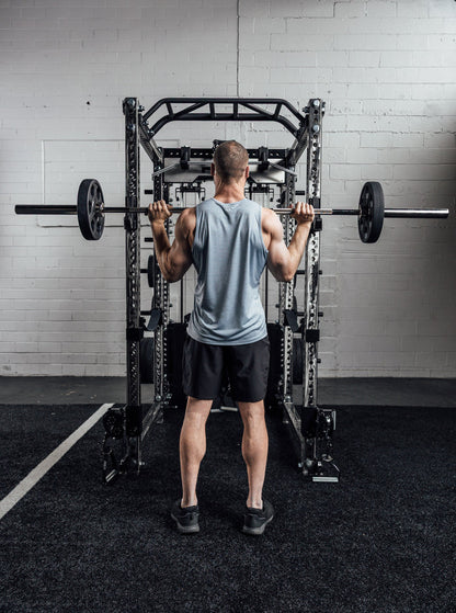 The REP Fitness Men's Sigmatech Tank Top in Heather Dusty Blue back, lifting barbell