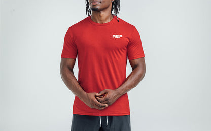 The REP Fitness Men's USA Tri-Blend Crew T-Shirt in Heather Red/White front, on model