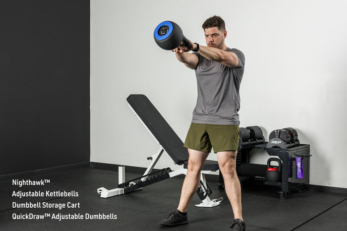 An athlete doing kettlebell swings with the adjustable Kettlebells