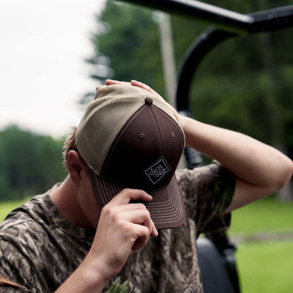 Muck® Diamond Trucker Hat, MACS900, Brown hat. man adjusting muck hat.  Richardson Hats.