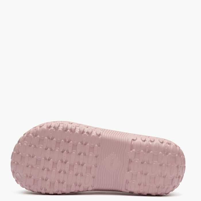 Pink slipper with textured sole on a white background