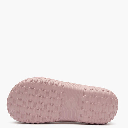Pink slipper with textured sole on a white background