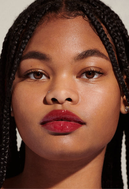 Model with glossy, tinted lips - wearing Raspberry Jelly Lip Tint
