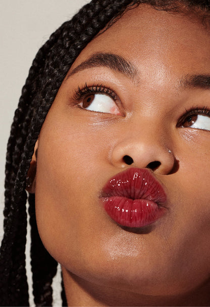 Model with glossy, tinted lips - wearing Raspberry Jelly Lip Tint