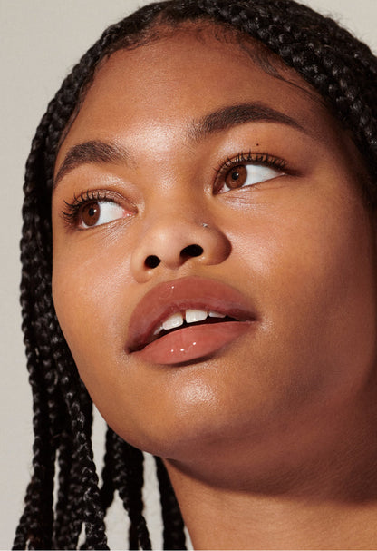 Model with glossy, tinted lips - wearing Toast Lip Tint