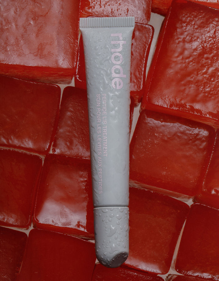 rhode peptide lip treatment in watermelon slice, on top of watermelon flavored ice cubes