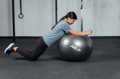 An athlete doing ball roll outs with the REP Physioball