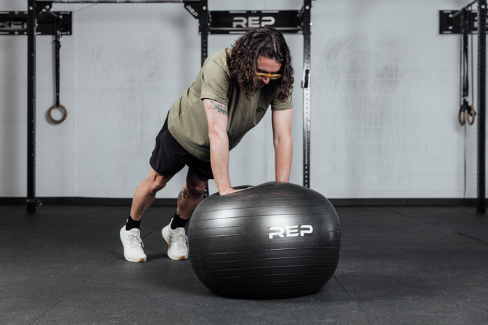 An athlete performs push ups on the Physioball.