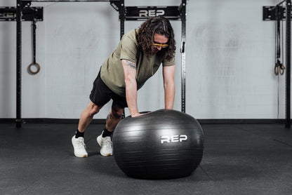 An athlete performs push ups on the Physioball.