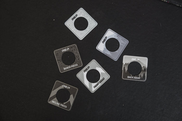 The REP Fitness Power Rack Magnetic Position Markers for 5000 Series racks sitting on a gym floor