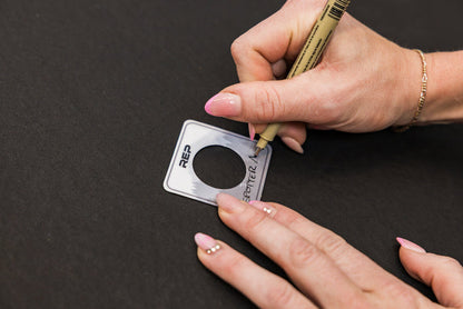 Athlete writing "Spotter Arms" on the blank Power Rack Magnetic Position Marker